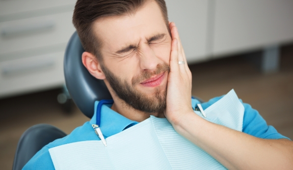 Man in pain before emergency dentistry treatment