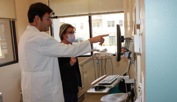 Dentists member reviewing dental patient's treatment plan