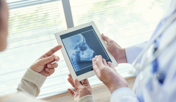 Dentist reviewing digital x-rays during dental checkup and teeth cleaning visit