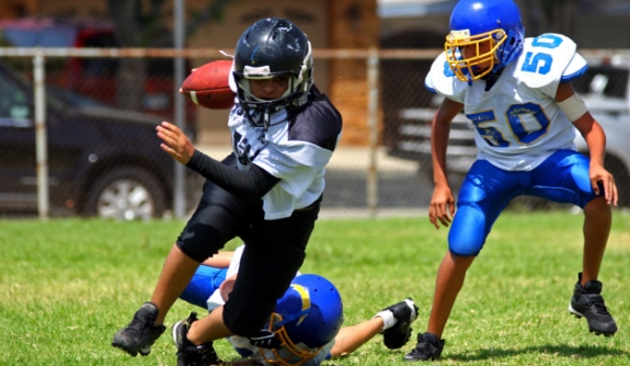 Group of children with athletic mouthguards playing football