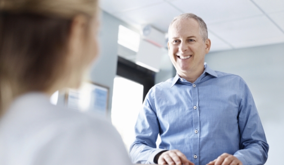 Man discussing the cost of dental emergencies with dentistry team member