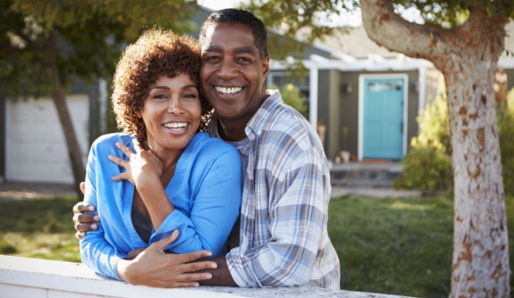 Man and woman enjoying the benefits of tooth replacement with dental implants