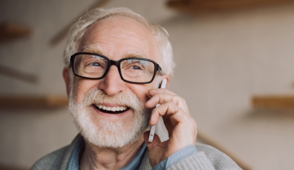 Man discussing the cost of tooth replacement with dental implants