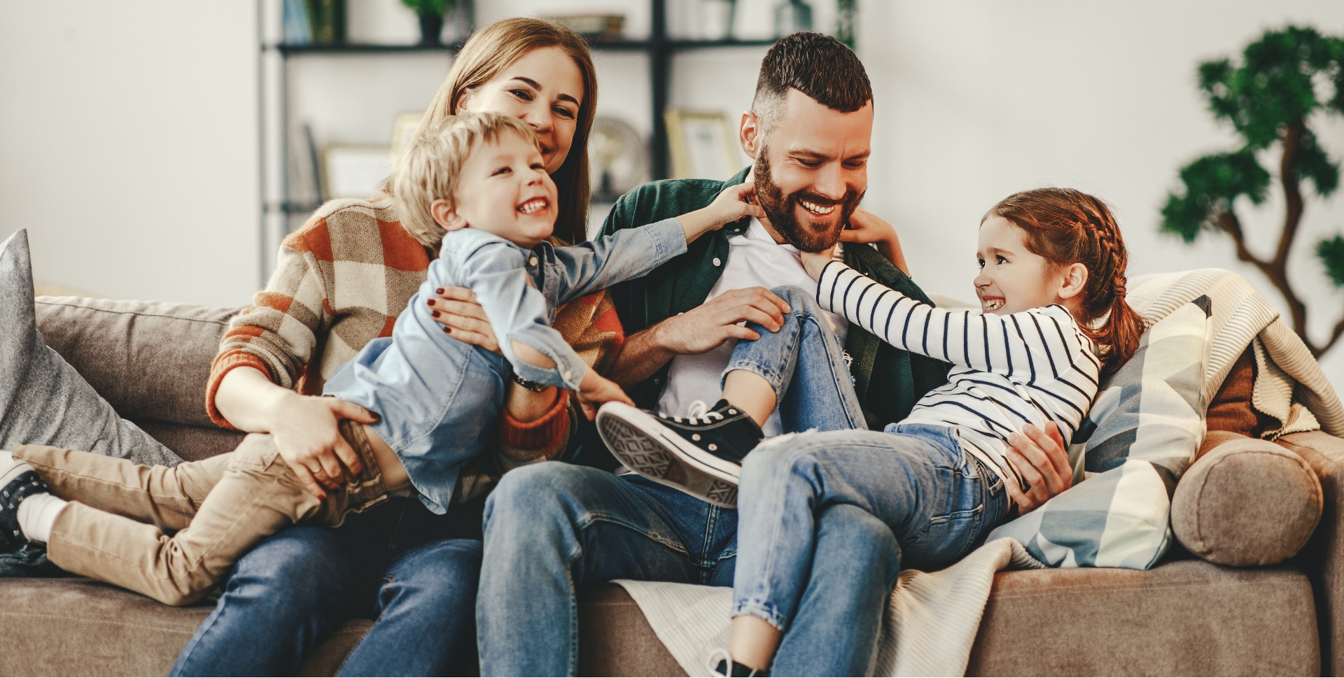 Family four laughing together after preventive dentistry