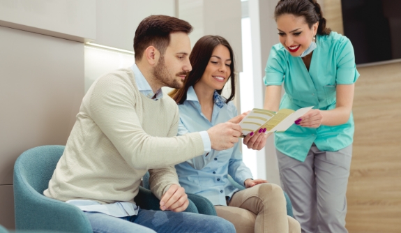 Dental team member discussing dental insurance coverage with dental patients