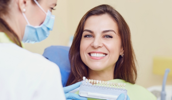 Woman sharing gorgeous smile after porcelain veneer treatment